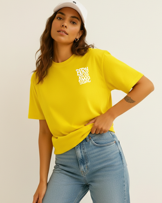 Woman wearing a yellow t-shirt with text and light blue jeans on a plain background